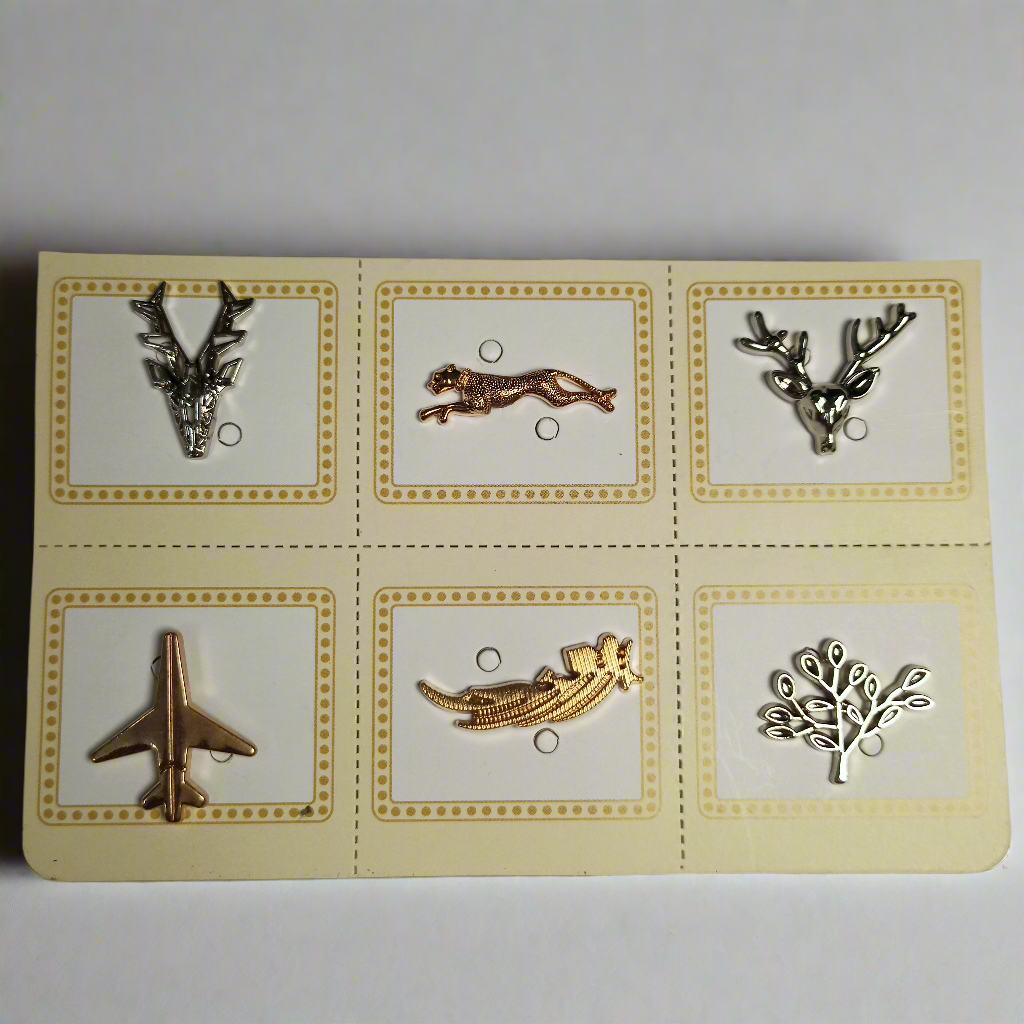 Brooch pins in silver, gold and black